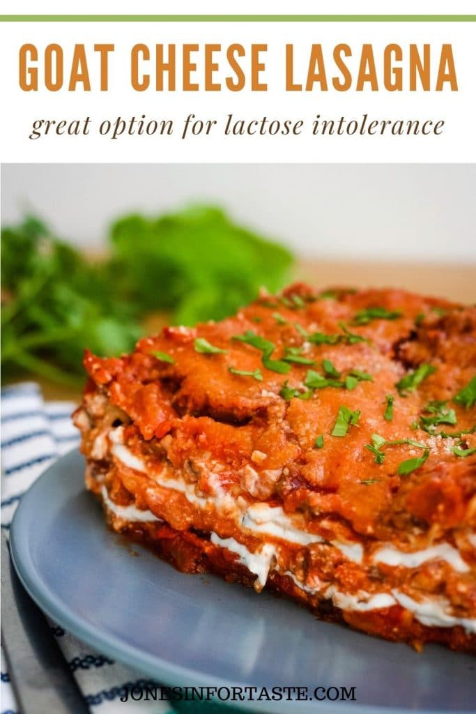 a slice of goat cheese lasagna on a blue plate with herbs in the background