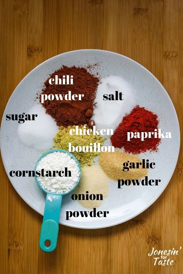 a white plate with small piles of colorful spices