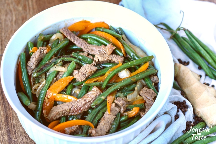 Cantonese Style black pepper beef with orange bell peppers, onions, and green beans.
