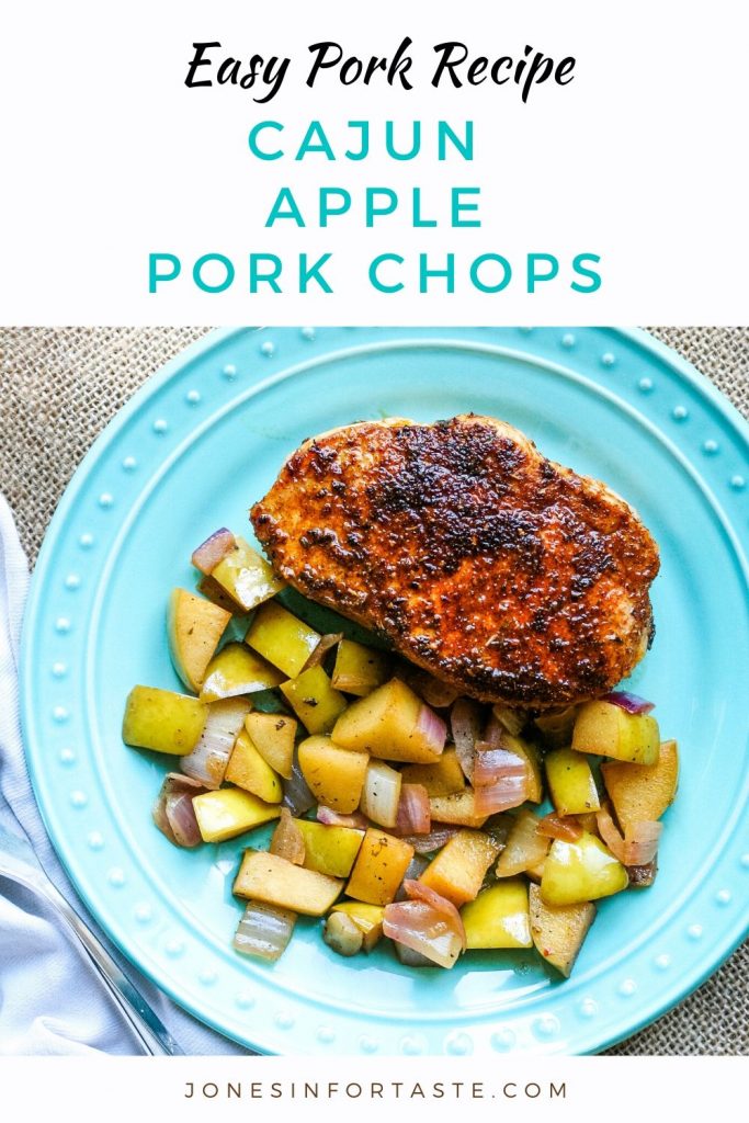 A Cajun pork chop on a blue plate next to sauteed apples and onions with a text graphic above