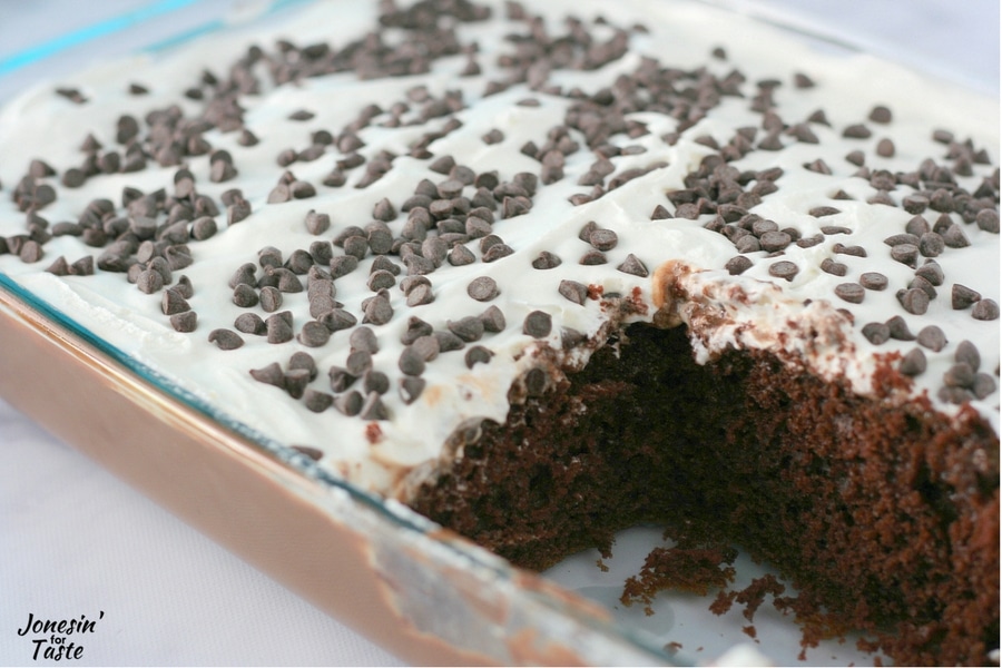 A pan of nutella poke cake with a big slice taken out.