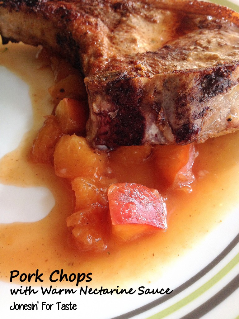 A close up of the nectarines in sauce on with a slice of pork chop on top of it.