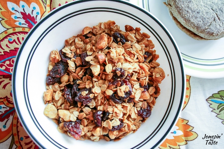 A bowl of granola on a patterned tablecloth