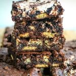 A stack of brownies with graham crackers, chocolate pieces, and marshmallow fluff