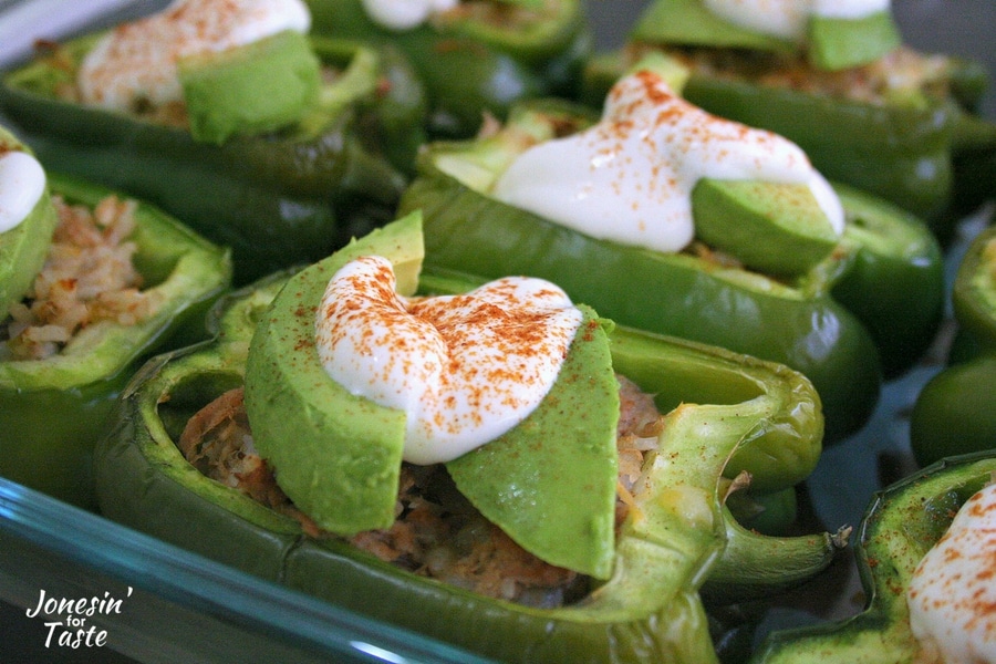 A Southwest Stuffed Pepper topped with Lime Yogurt Sauce, avocados, and paprika