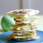 A tall stack of Apple Feta Quesadillas on a blue plate