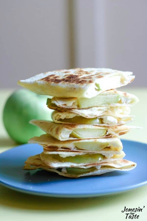 A tall stack of Apple Feta Quesadillas on a blue plate