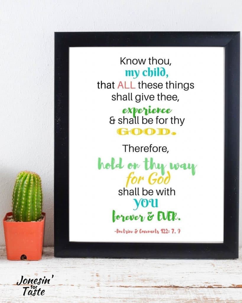 a photo of a black picture frame with the quote printable inside next a tiny cactus in an orange planter