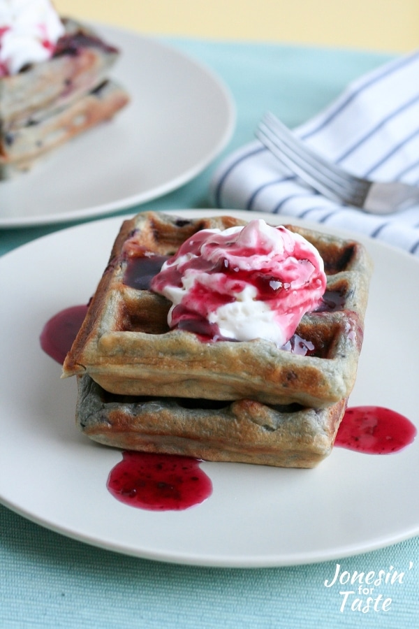 A stack of blackberry waffles on a plate