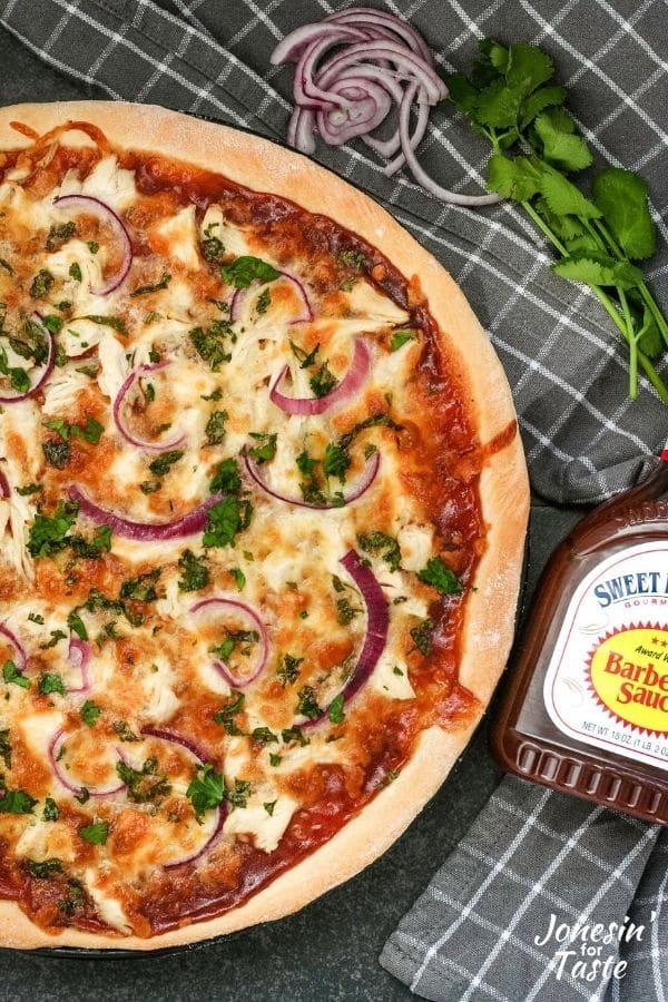cilantro, onion, and BBQ sauce next to a pizza
