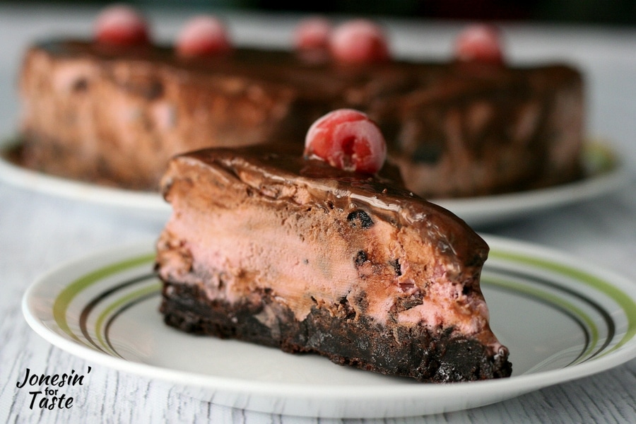 A slice of Cherry Chocolate Ice Cream Brownie Cake on a plate.