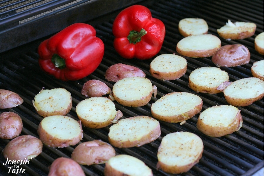 Potatoes and red peppers being grilled