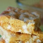 A square of a white chocolate peanut butter cookie bars on top of a pile.
