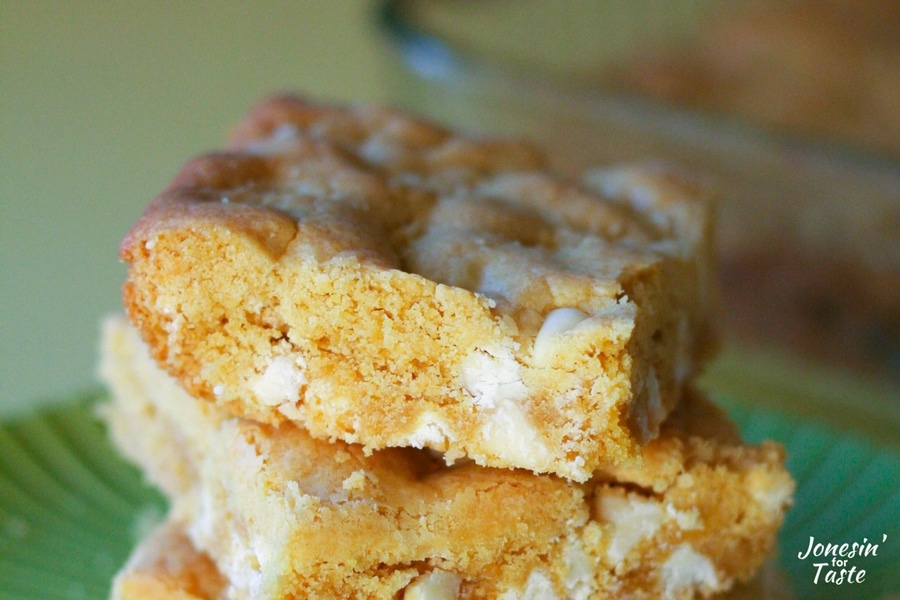 A square of a white chocolate peanut butter cookie bars on top of a pile.
