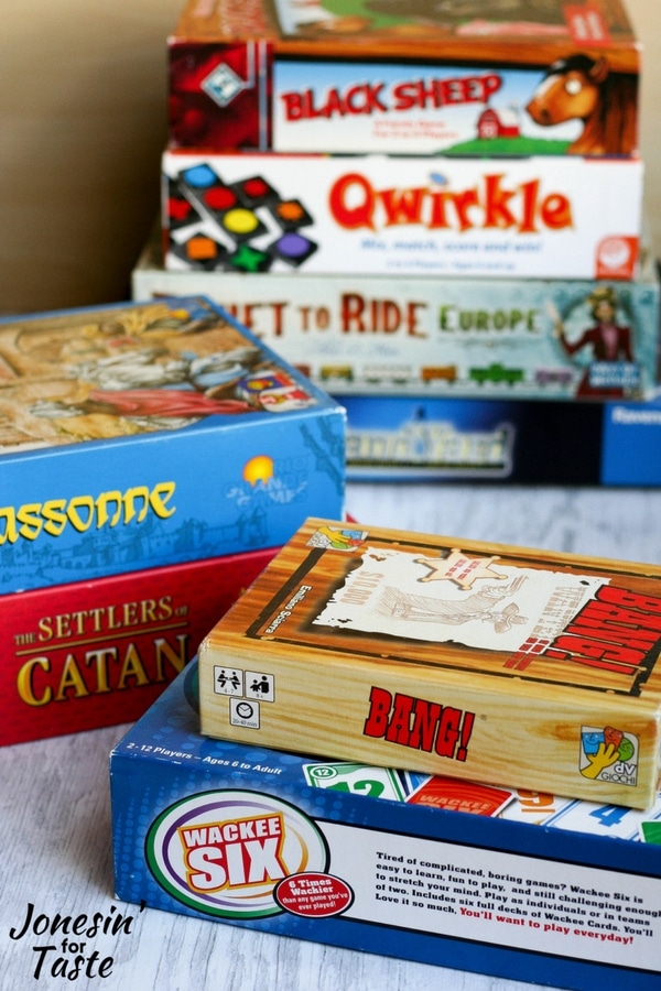 Stacks of board games for family game night in various piles