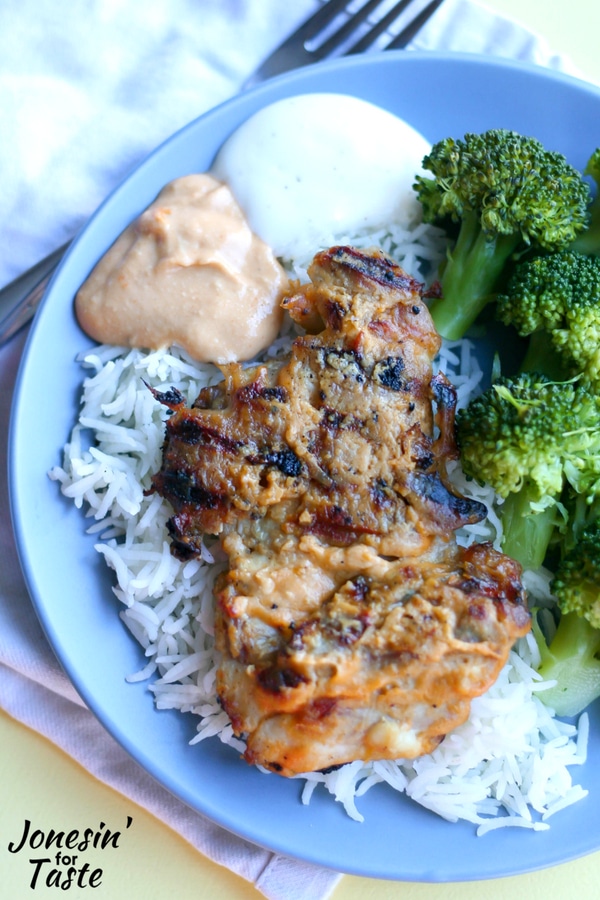 Lighter grilled buffalo chicken on a bed of basmati rice with steamed broccoli and dollops of extra buffalo hummus sauce and ranch dressing.
