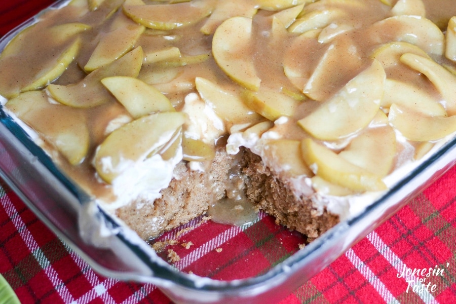 The apple spice poke cake with a slice missing