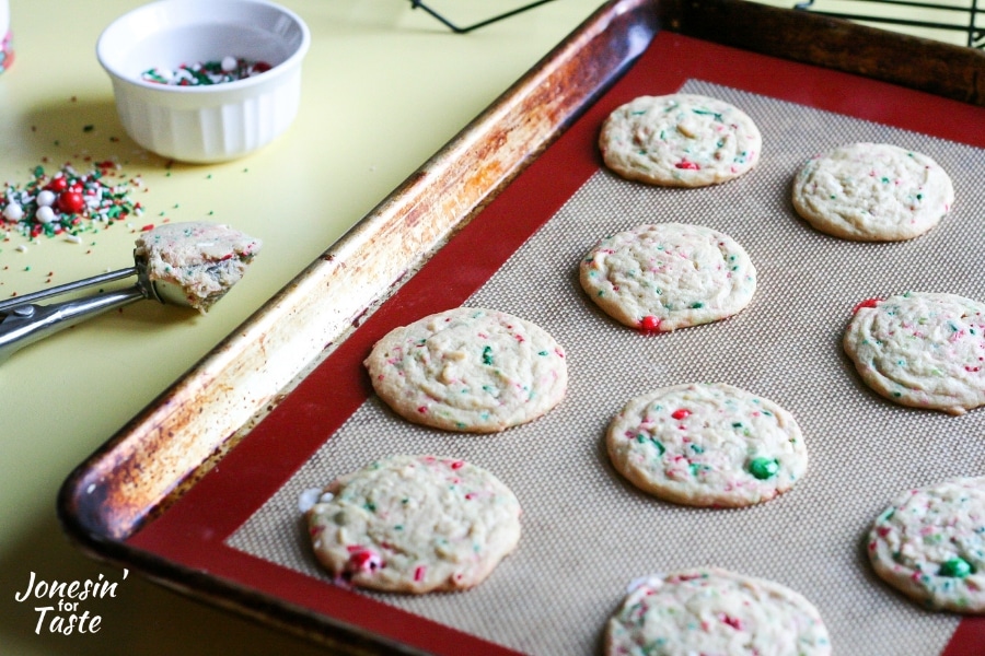 Baked Christmas Sprinkle pudding cookies on a cookie sheet