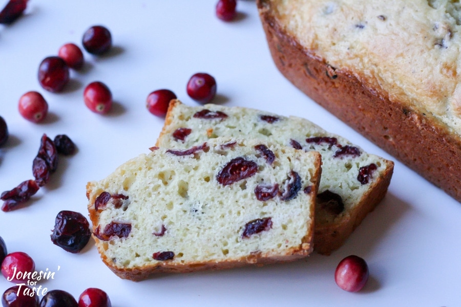 Slices of cranberry eggnog bread surrounded by cranberries