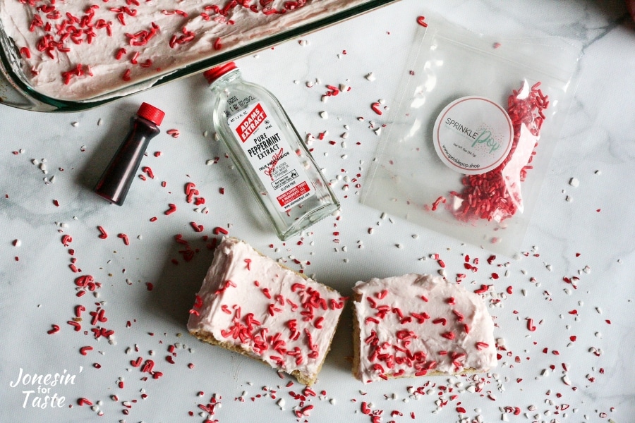 Iced peppermint cookie bars with extract bottle and sprinkles packet