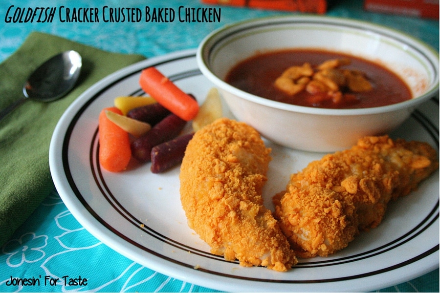 Strips of Goldfish Cracker Crusted Baked Chicken with rainbow carrots and a bowl of tomato soup
