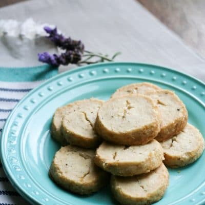 Lavender cookies stacked in layers on a plate.