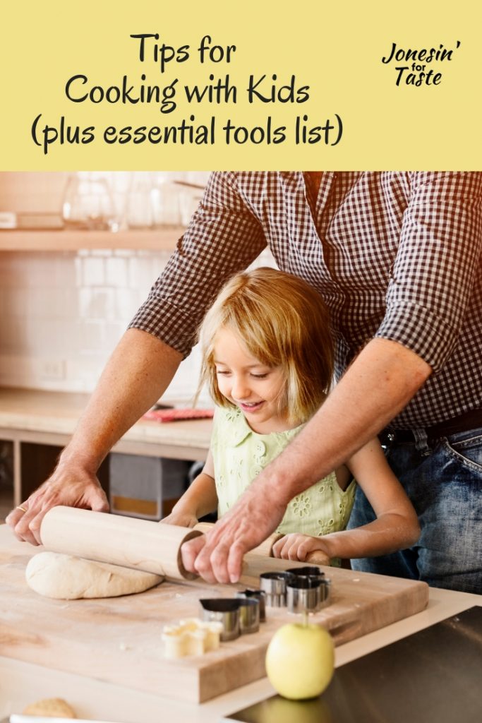 A girl using a rolling pin with her dad