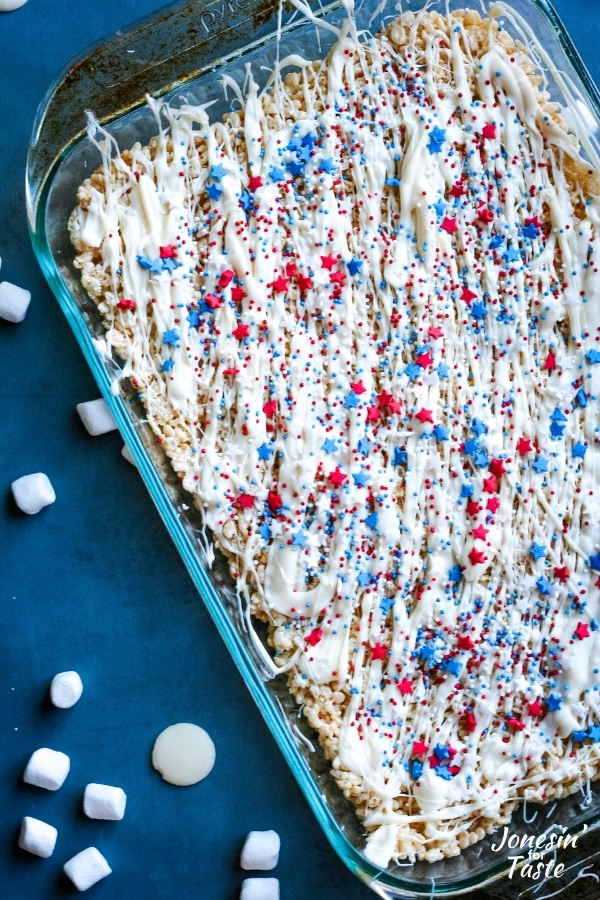 a pan of rice krispies decorated with white chocolate and sprinkles