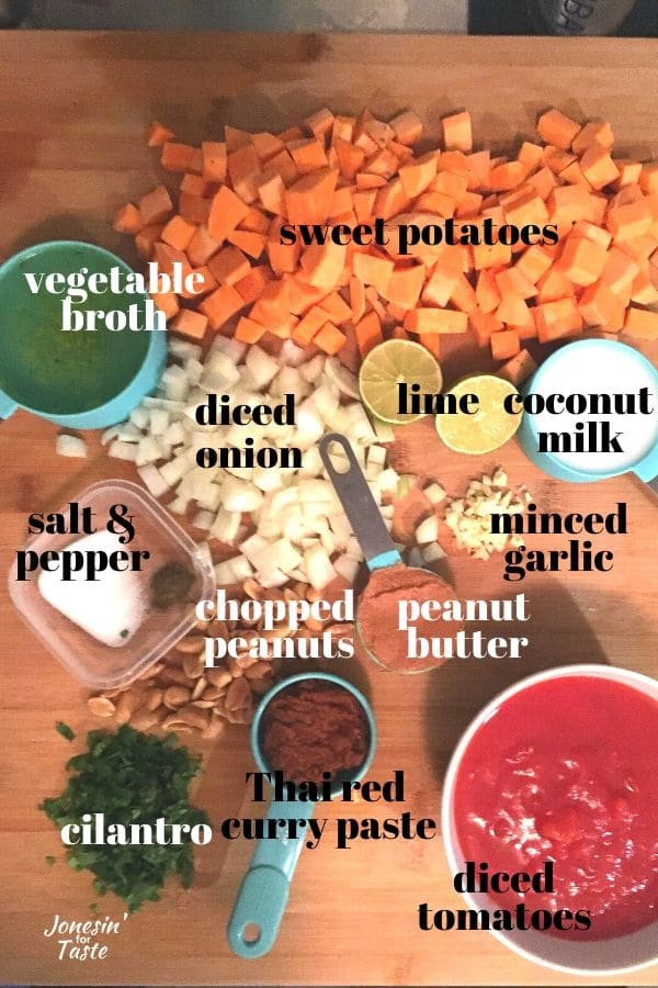 a cutting board with all of the ingredients needed for sweet potato curry