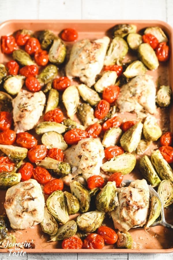 chicken, tomatoes, and brussel sprouts mixed up and spread on a cookie sheet