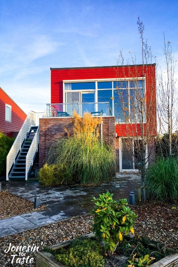 a two story home painted orange red