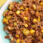 a close up of the picadillo with olives, corn, and raisins