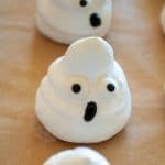 a meringue ghost with candy eyes and an icing mouth