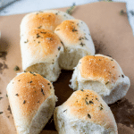 rolls pulled away from the loaf on a piece of parchment paper