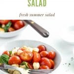 two white bowls filled with caprese salad and a fork resting on top below a text graphic that reads caprese salad, fresh summer salad