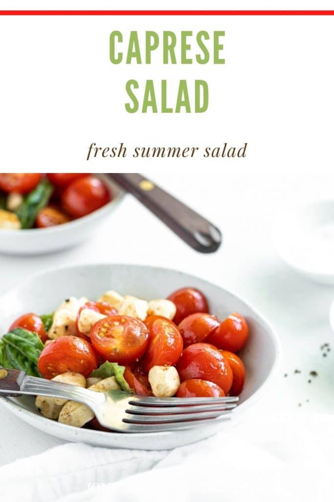 two white bowls filled with caprese salad and a fork resting on top below a text graphic that reads caprese salad, fresh summer salad