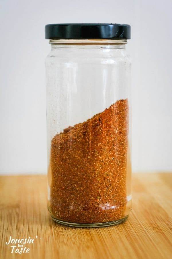 a jar with an uneven level of spices inside the jar