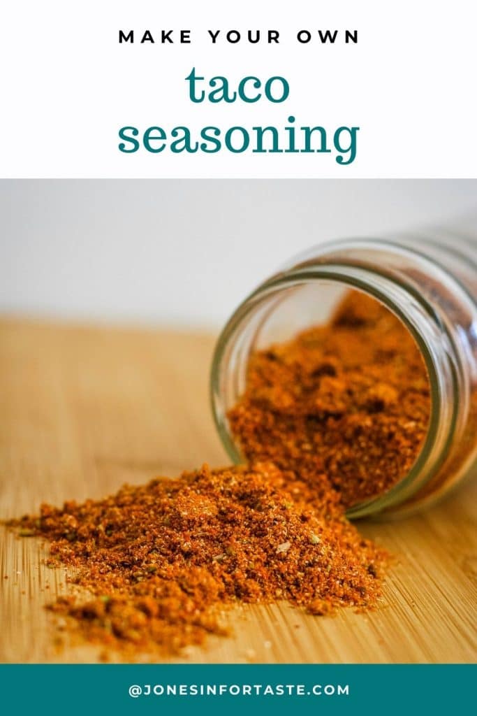 spices spilled out of a jar that is tipped over on its side on a cutting board, text above the photo says make your own taco seasoning