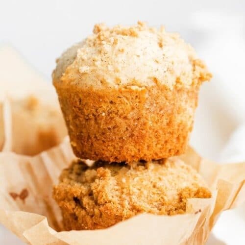 a pair of coffee cake muffins stacked on top of one another