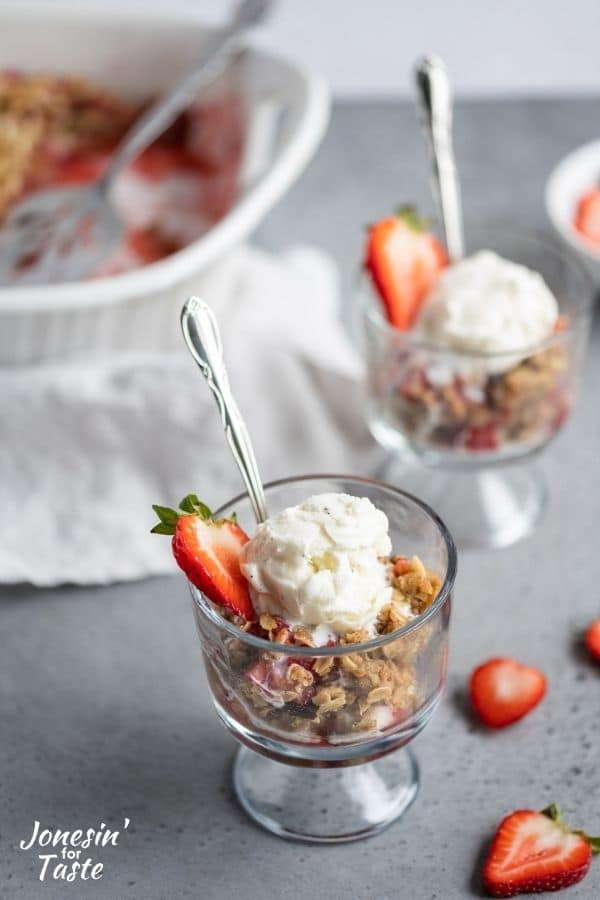 2 glasses of strawberry rhubarb crisp with a scoop of vanilla on top