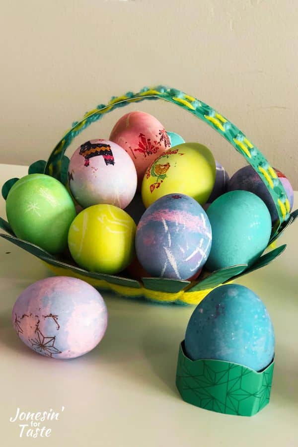 the basket craft filled with dyed Easter eggs, some decorated with tattoos